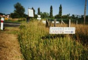 A sign at the side of a country road that reads 'Chambre D'Hotes LANCRE (99K)